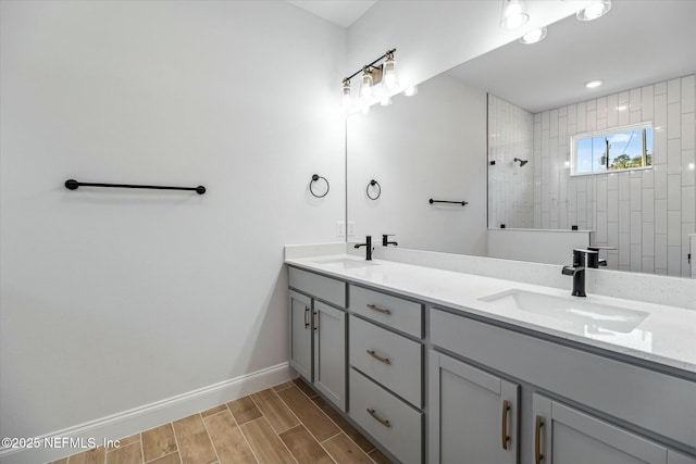 bathroom with vanity and tiled shower