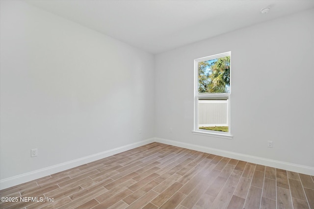 empty room with light hardwood / wood-style flooring