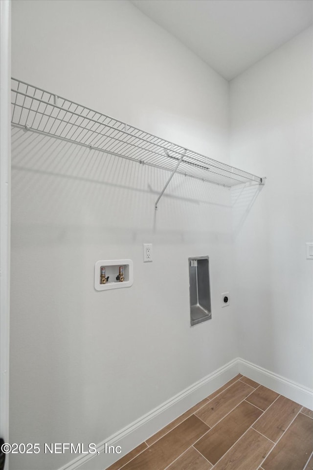 clothes washing area featuring hookup for an electric dryer and hookup for a washing machine