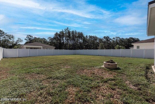 view of yard with an outdoor fire pit