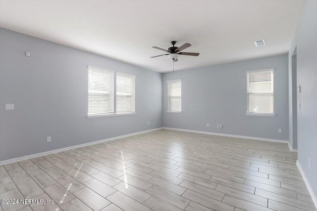 unfurnished room with light wood-type flooring and ceiling fan