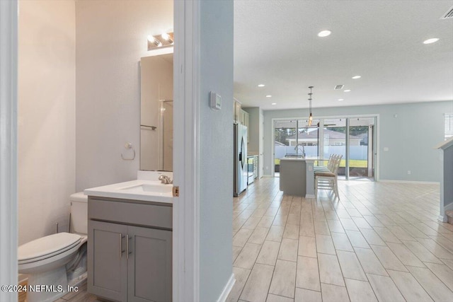 bathroom featuring hardwood / wood-style floors, vanity, and toilet