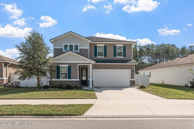 view of front of home featuring a front yard and a garage