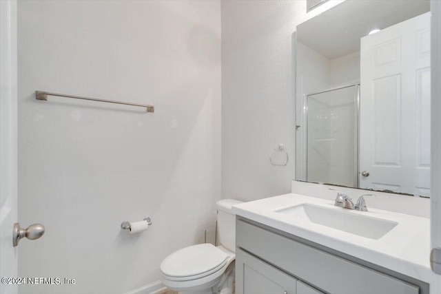 bathroom featuring a shower, vanity, and toilet