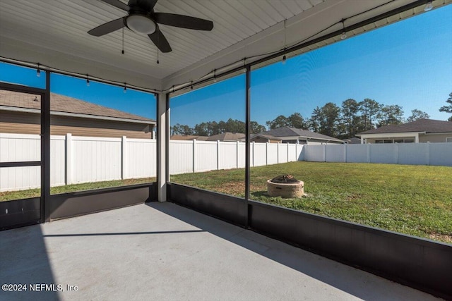 unfurnished sunroom featuring ceiling fan