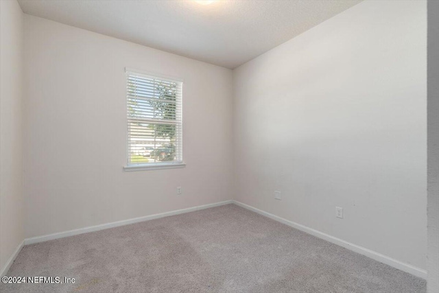 unfurnished room featuring carpet