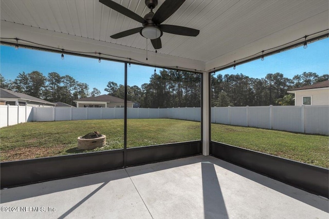 unfurnished sunroom with ceiling fan