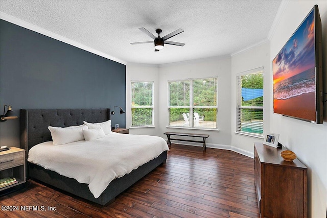 bedroom with ceiling fan, crown molding, dark wood-type flooring, and a textured ceiling