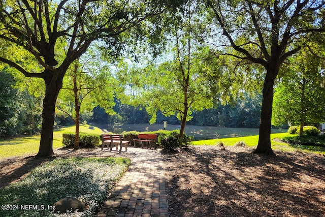 view of property's community with a yard and a water view