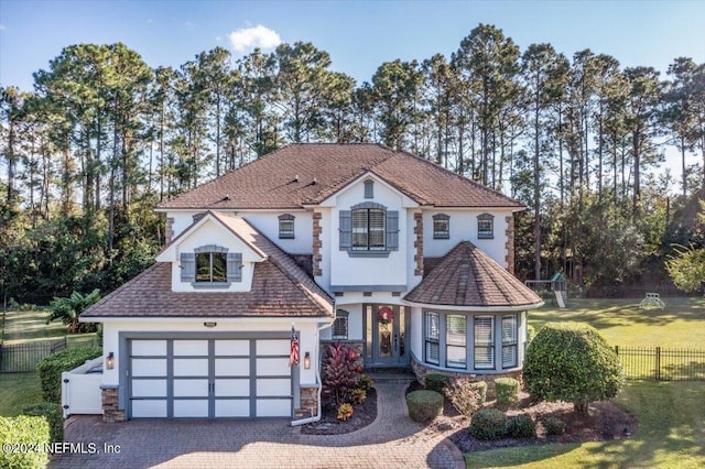 view of front of home featuring a front yard and a garage