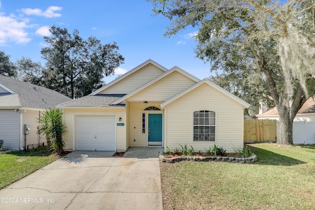 view of front of property with a garage and a front yard