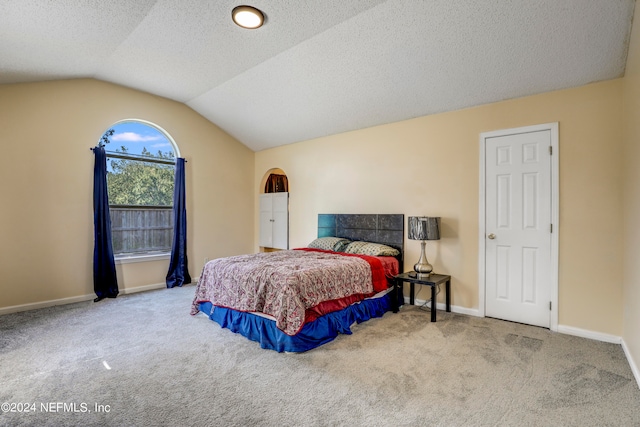 carpeted bedroom featuring vaulted ceiling