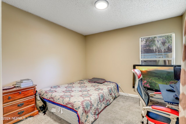 carpeted bedroom with a textured ceiling