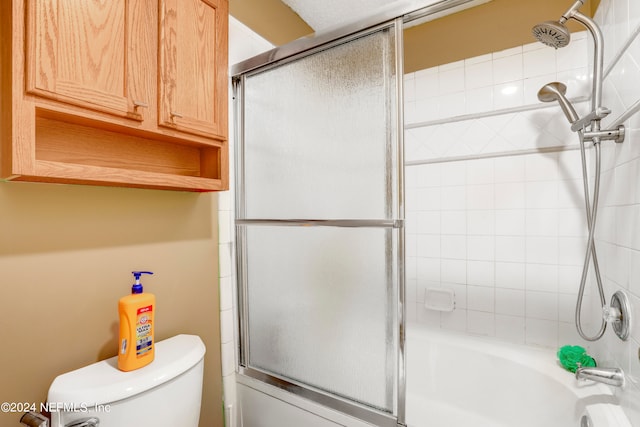 bathroom with shower / bath combination with glass door and toilet