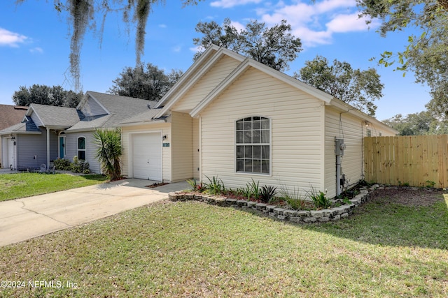 view of front of home with a front lawn and a garage