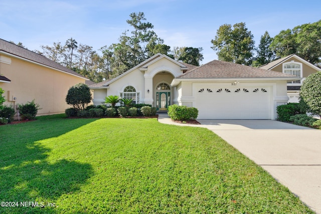 view of front facade with a garage and a front lawn