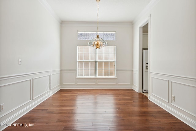 unfurnished dining area with a notable chandelier, crown molding, and dark hardwood / wood-style floors