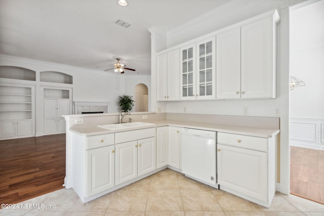 kitchen with white cabinets, white dishwasher, light hardwood / wood-style floors, and sink