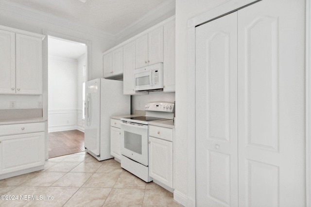 kitchen with white appliances, crown molding, white cabinets, and light wood-type flooring