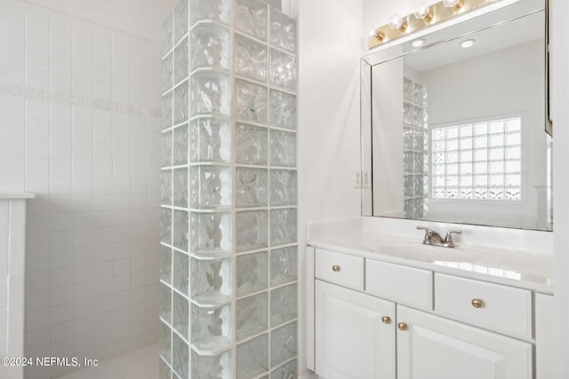 bathroom with vanity and tiled shower