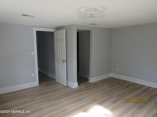 unfurnished room featuring light wood-type flooring