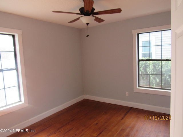 spare room featuring dark hardwood / wood-style floors and ceiling fan