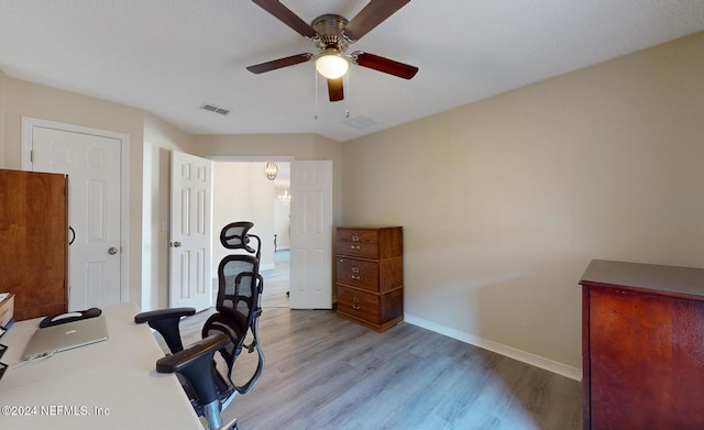 exercise area featuring light wood-type flooring, baseboards, and ceiling fan