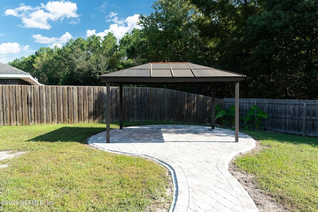 surrounding community with a gazebo and a patio area