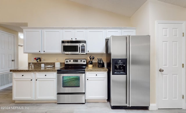 kitchen featuring light hardwood / wood-style flooring, lofted ceiling, white cabinets, and stainless steel appliances