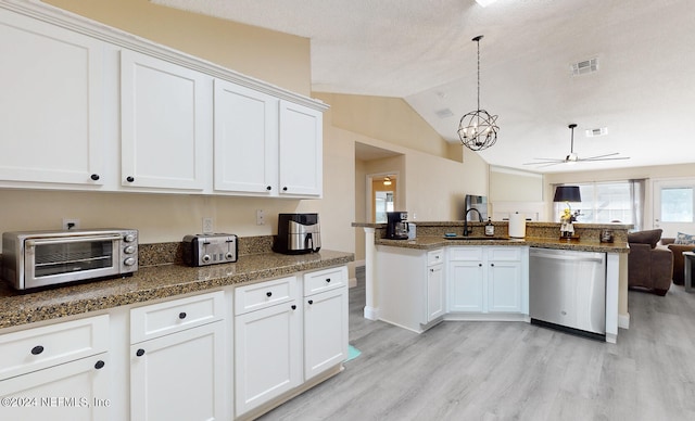 kitchen with hanging light fixtures, white cabinetry, stainless steel dishwasher, light wood-type flooring, and vaulted ceiling