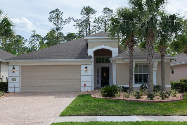 view of front facade featuring a front yard and a garage