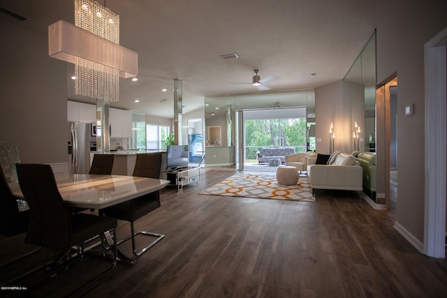 living room with ceiling fan and dark hardwood / wood-style flooring