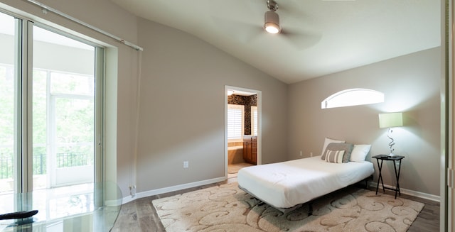 bedroom with ensuite bathroom, access to exterior, light hardwood / wood-style floors, ceiling fan, and lofted ceiling