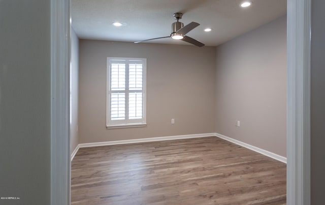 spare room with light hardwood / wood-style flooring and ceiling fan