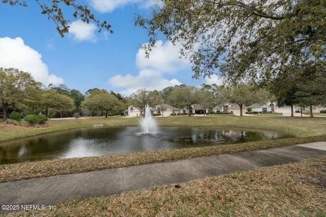 surrounding community with a lawn and a water view