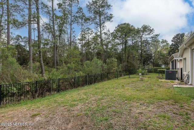 view of yard featuring central air condition unit and a fenced backyard