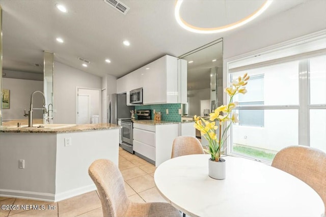 dining space featuring lofted ceiling, light tile patterned floors, recessed lighting, and visible vents