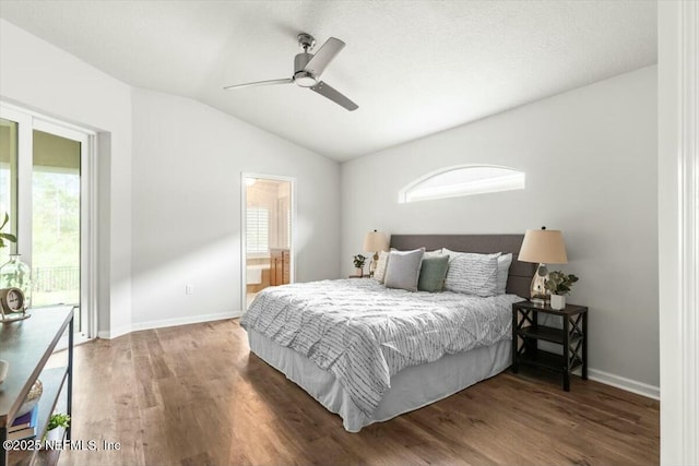 bedroom featuring access to exterior, vaulted ceiling, baseboards, and wood finished floors