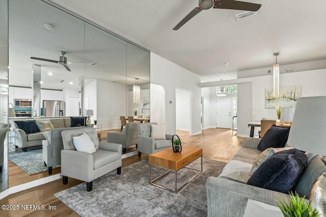 living room with recessed lighting, wood finished floors, visible vents, and ceiling fan