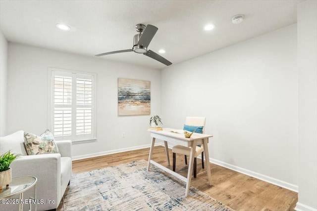 office space with baseboards, wood finished floors, and a ceiling fan