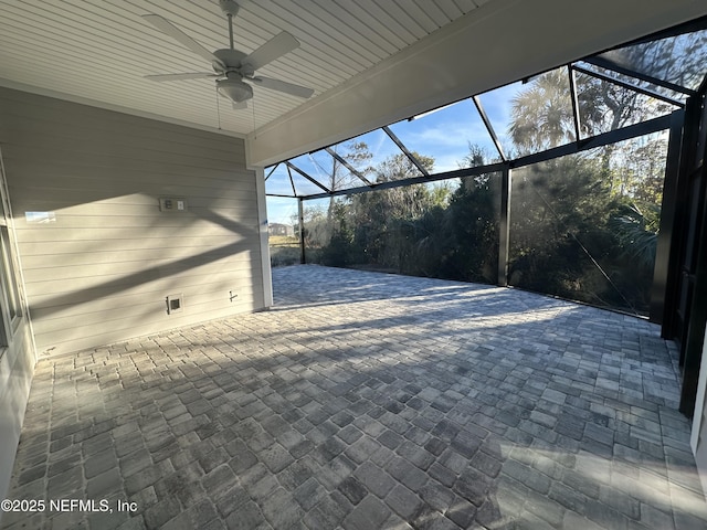 view of patio / terrace featuring ceiling fan and glass enclosure