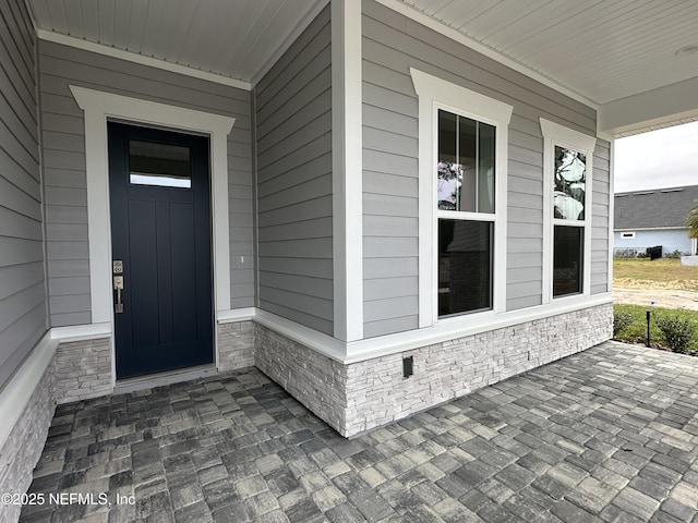 doorway to property featuring a porch