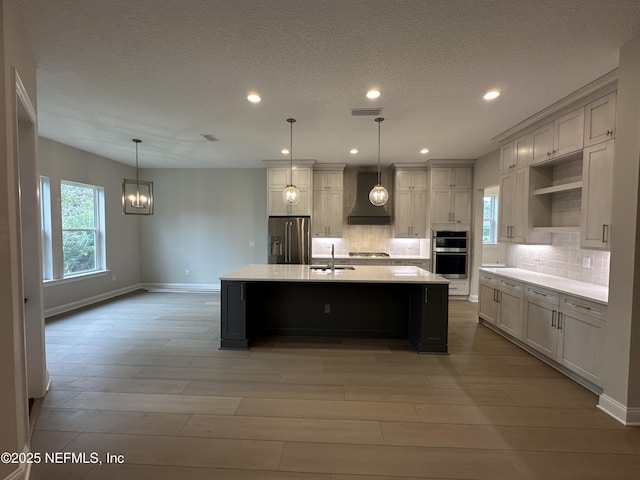 kitchen featuring premium range hood, a sink, appliances with stainless steel finishes, open shelves, and tasteful backsplash