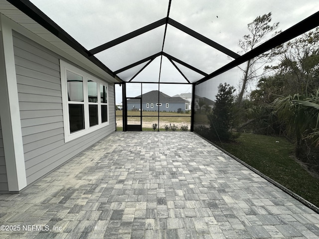 unfurnished sunroom featuring lofted ceiling