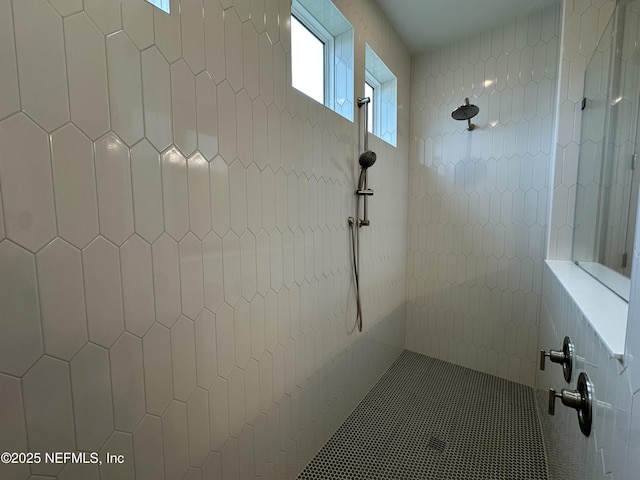 bathroom with a tile shower