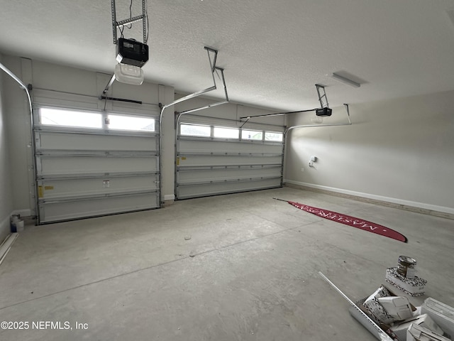 garage with a garage door opener and baseboards