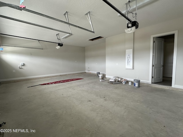 garage with baseboards and a garage door opener