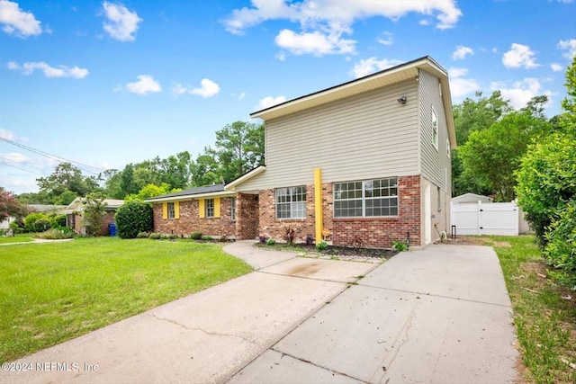 view of side of home featuring a yard