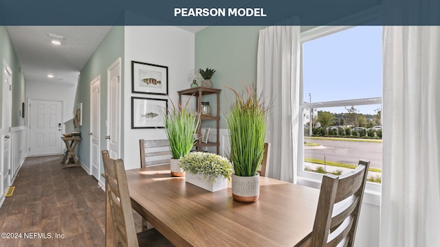 dining room with dark hardwood / wood-style flooring and a healthy amount of sunlight