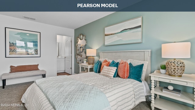 carpeted bedroom with ensuite bath, visible vents, and baseboards